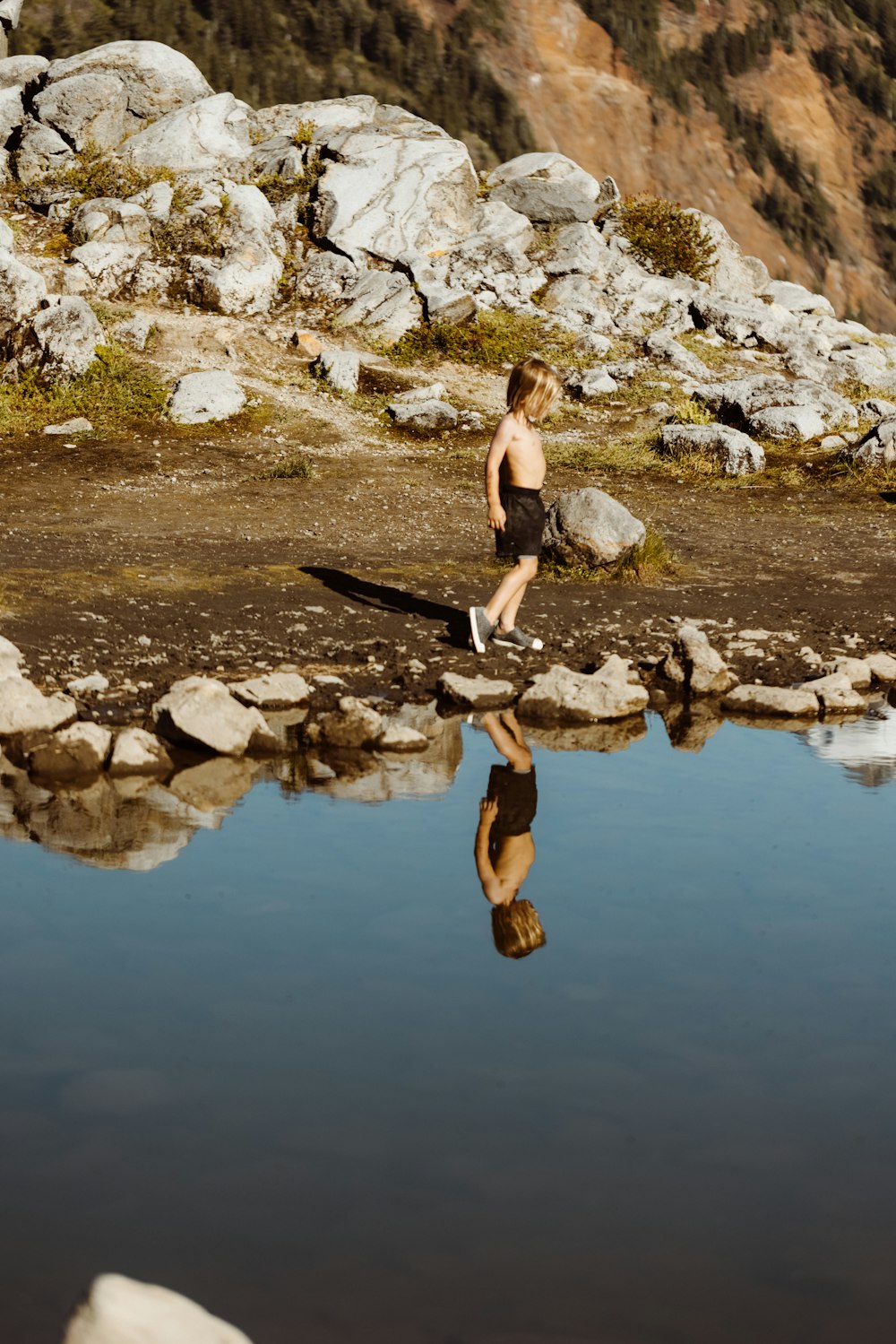 woman in black bikini jumping on water during daytime