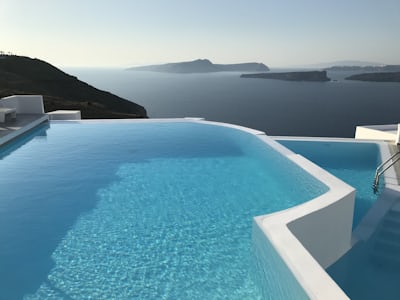 a hotel pool in a Greek island viewing the sea