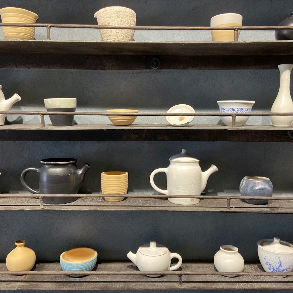 white ceramic teacup on brown wooden shelf