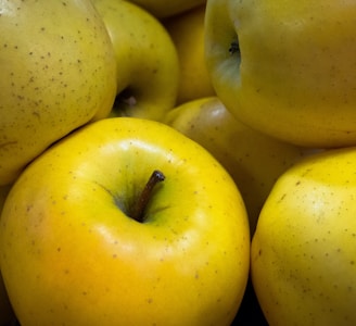 green apple fruit on yellow plastic container