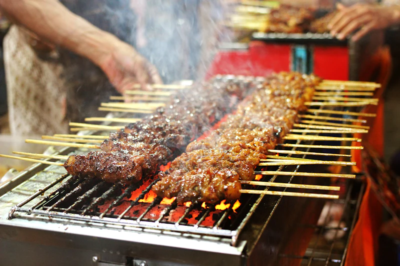 Meat grilling over charcoal