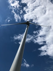 Wind turbines spinning against a clear blue sky.