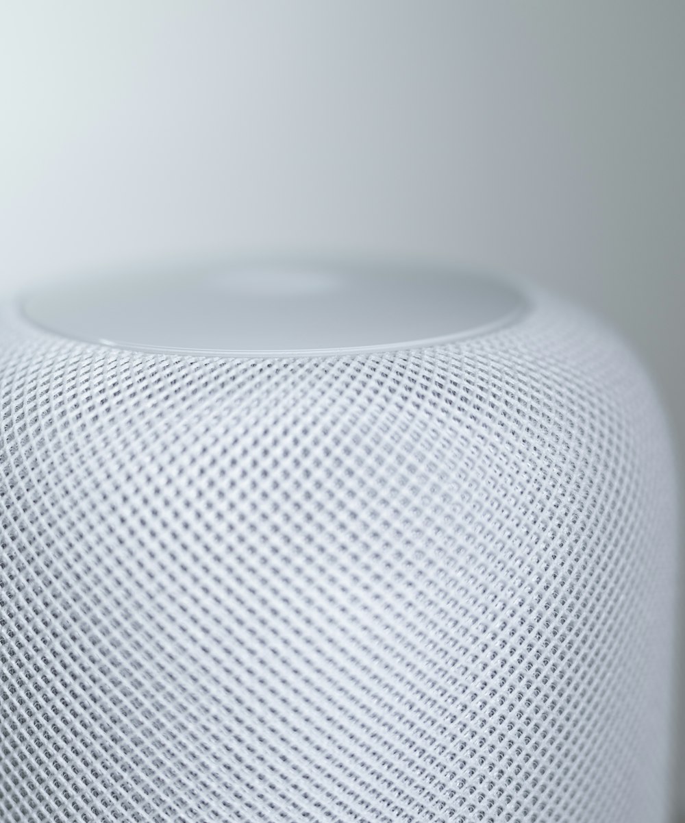 white round speaker on white table
