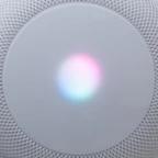 A modern wireless router with neon pink and green LED indicators glowing.