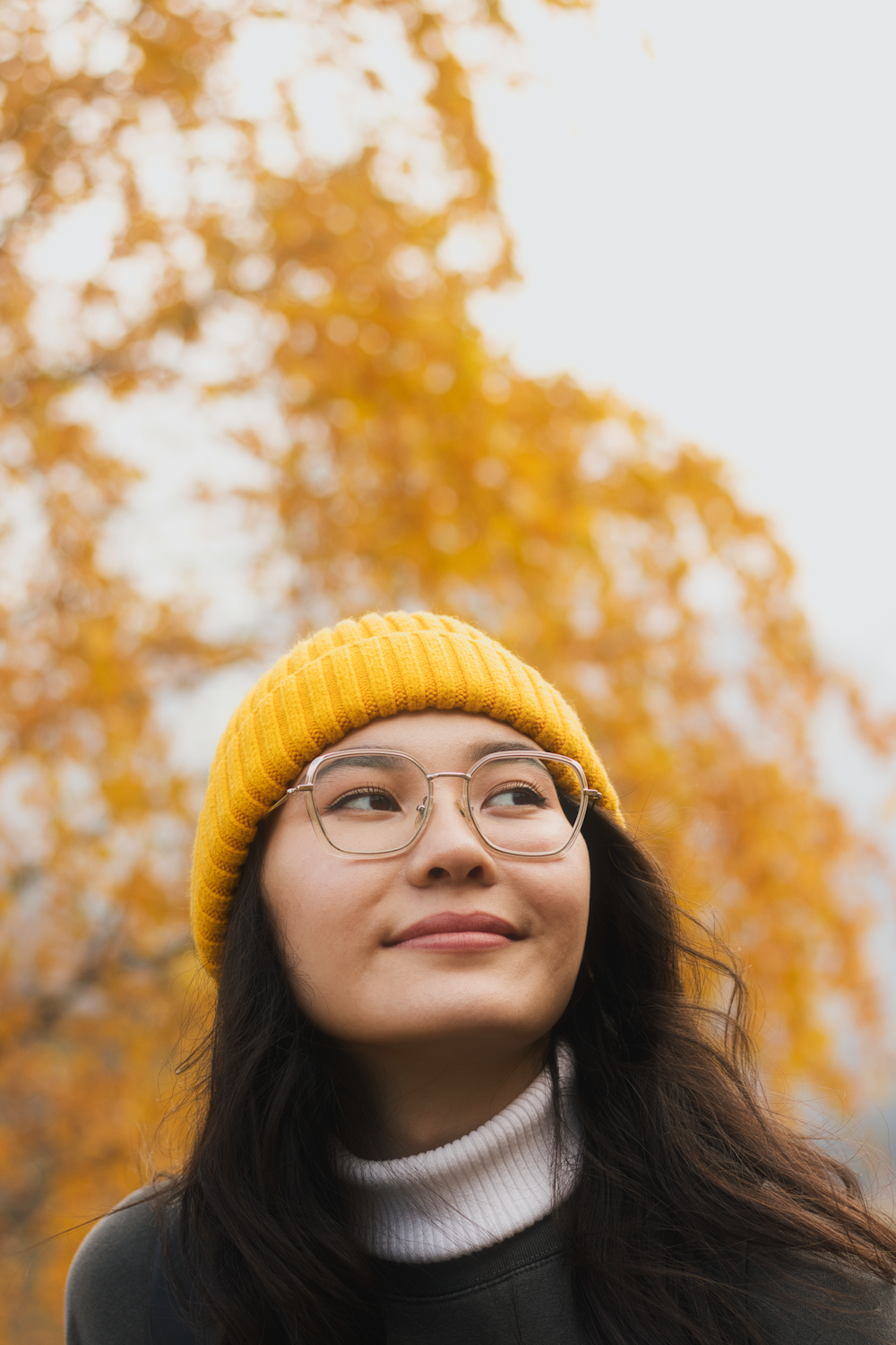 woman in yellow knit cap and black framed eyeglasses