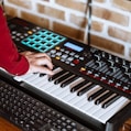 person playing black and white electric piano