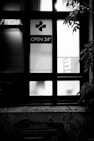 grayscale photo of black wooden framed glass window
