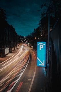 cars on road between buildings during night time