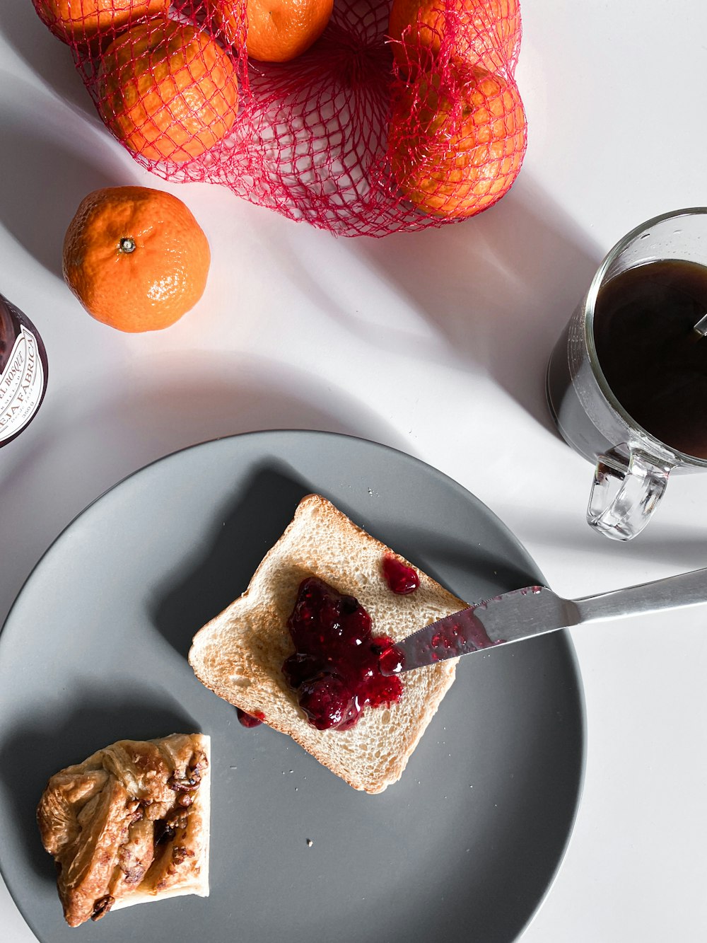 sliced bread on white ceramic plate beside clear drinking glass