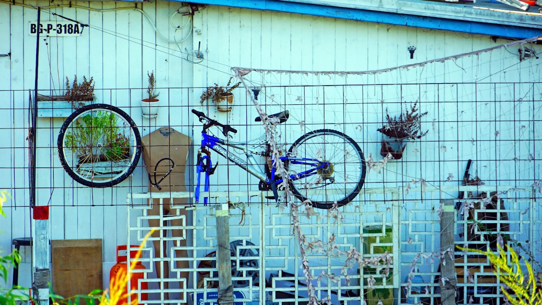 black and gray bicycle hanging on white wall