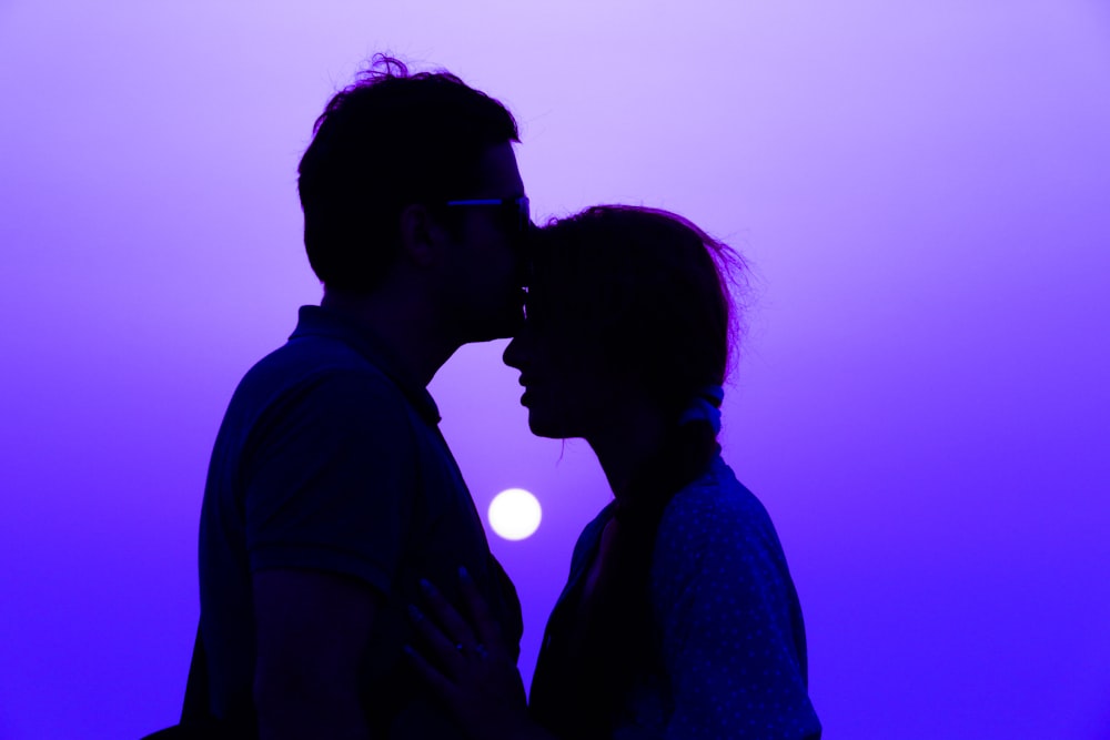 silhouette of man and woman during sunset