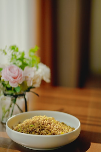 Elegant bowl of Fortuna rice with steam rising, set on a kitchen counter