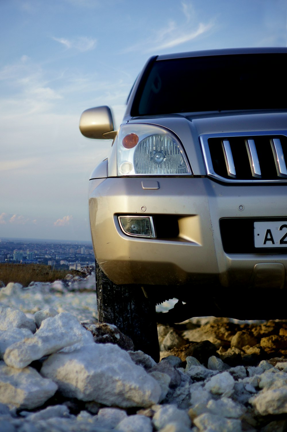 white and black jeep car on gray rocky shore during daytime