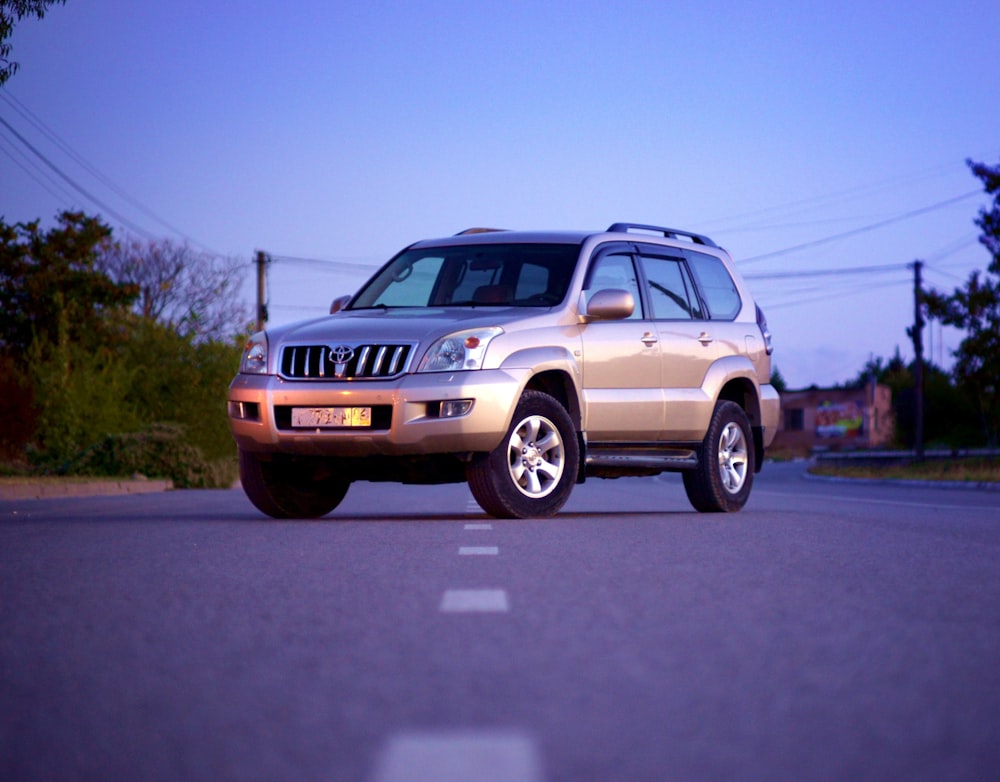 white suv on road during daytime