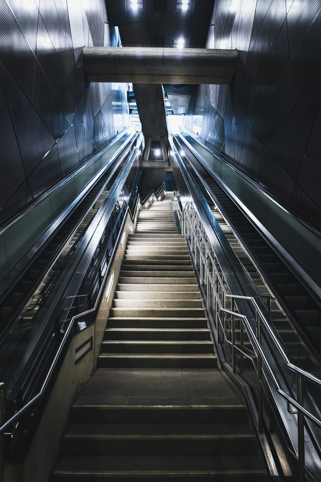 black and white escalator in tunnel