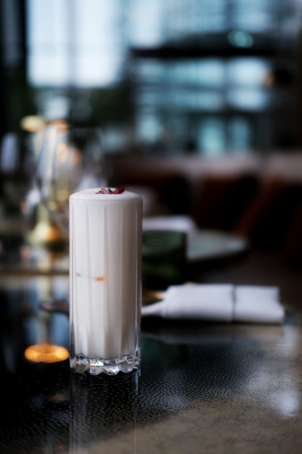 White pillar candle on clear glass holder
