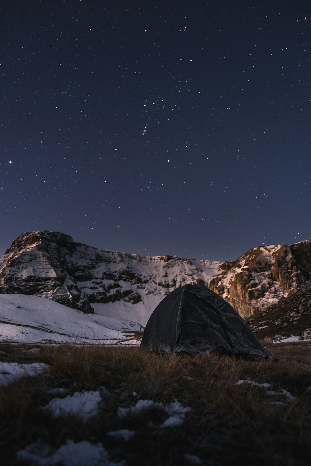 green tent on brown grass field during night time