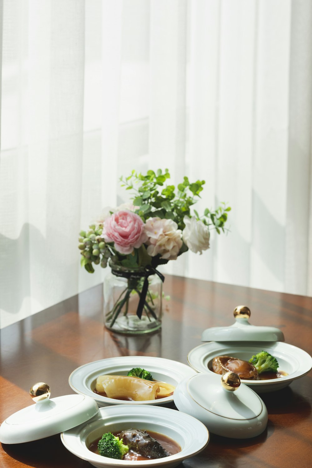 pink roses in clear glass vase on table