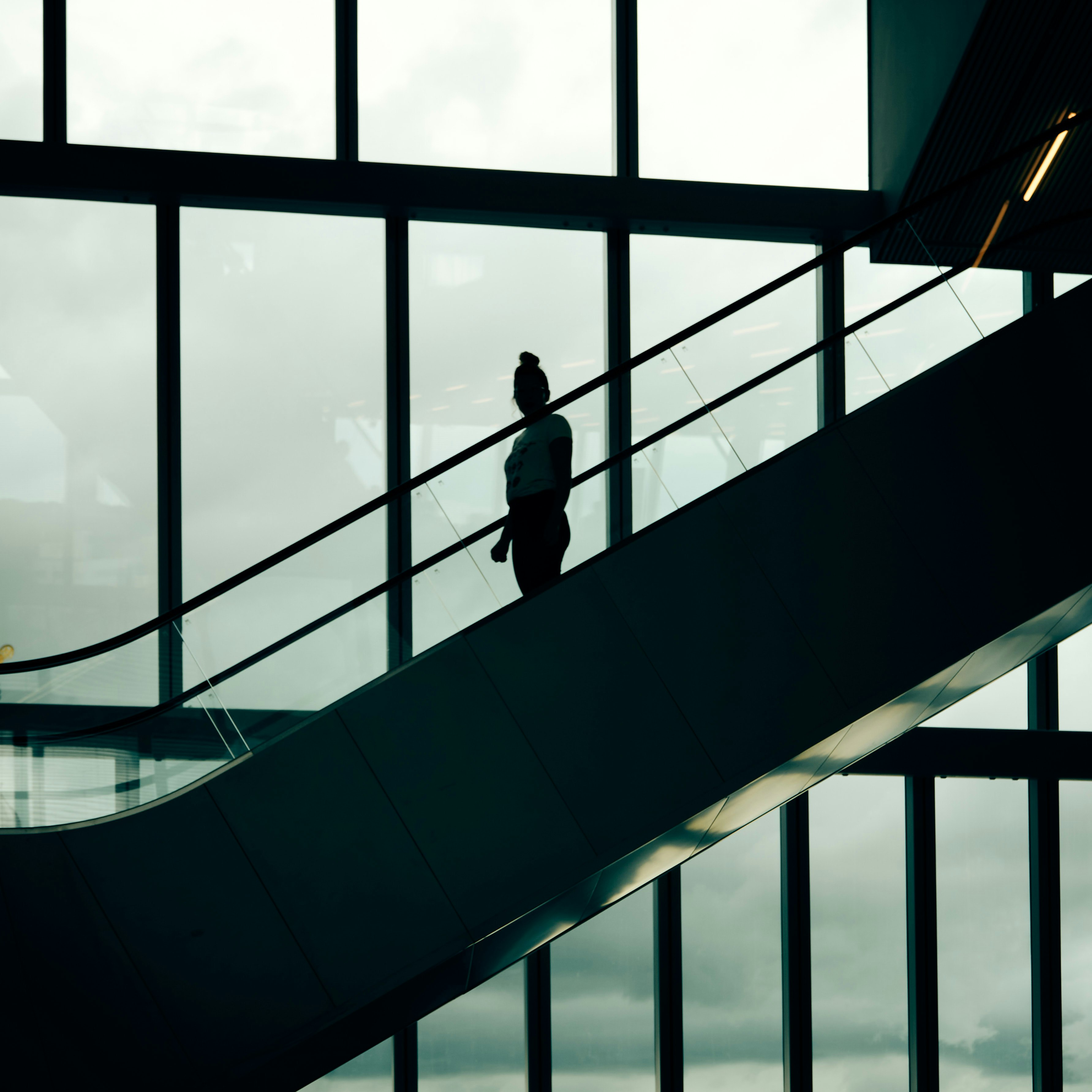 man in black jacket standing on black staircase