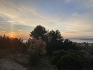 Sunrise over Chopta meadows with Tungnath temple silhouetted against a colorful sky.