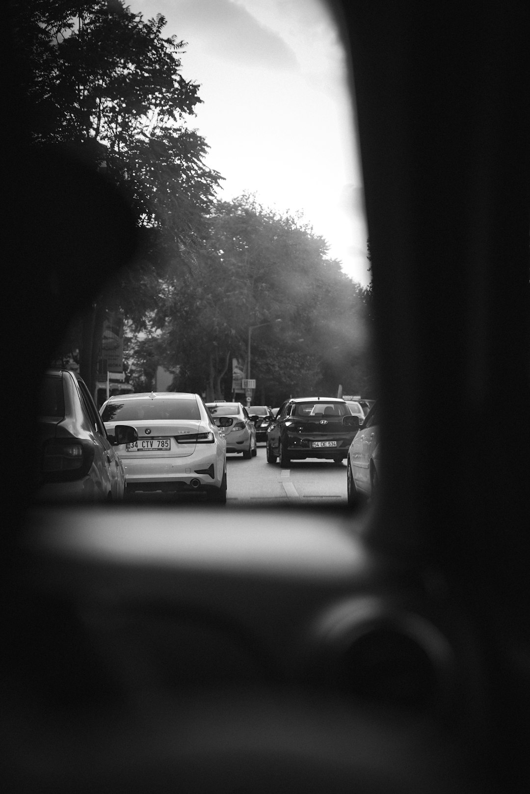 grayscale photo of cars on road