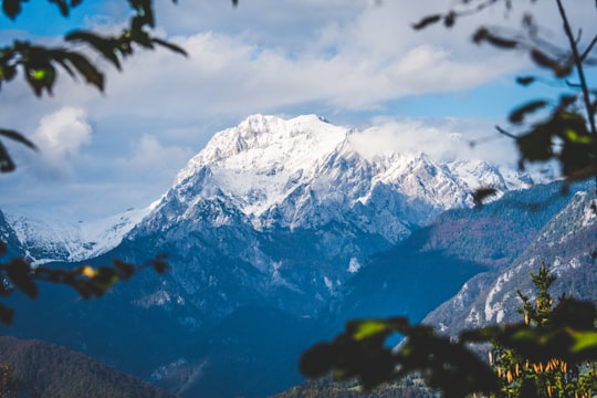 snow covered mountain under cloudy sky during daytime in Kamnik Slovenia