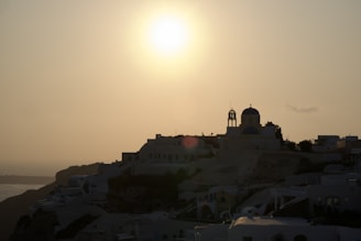 A breathtaking view of Santorini's iconic white buildings against a sunset.