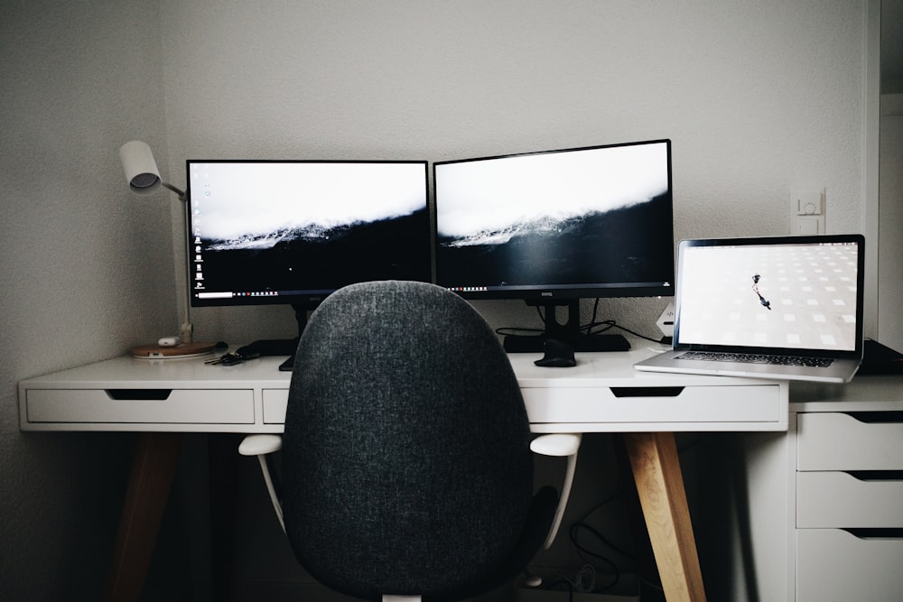 2 black flat screen computer monitor on white wooden desk