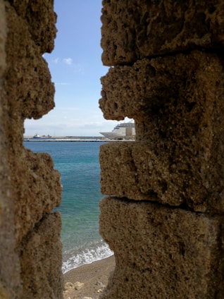 A stunning view of a cruise ship sailing on a clear blue ocean.