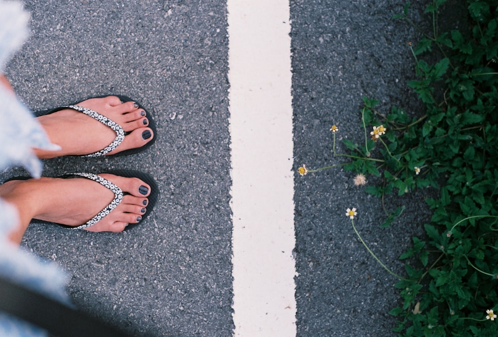 person wearing brown leather sandals