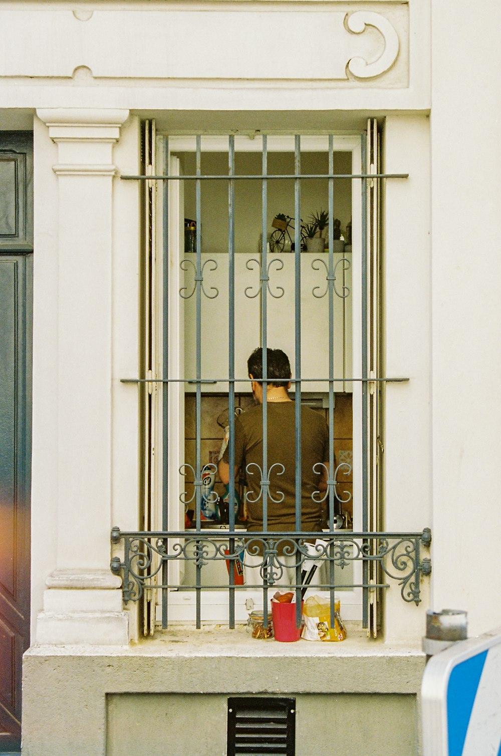 black metal gate with woman in black dress