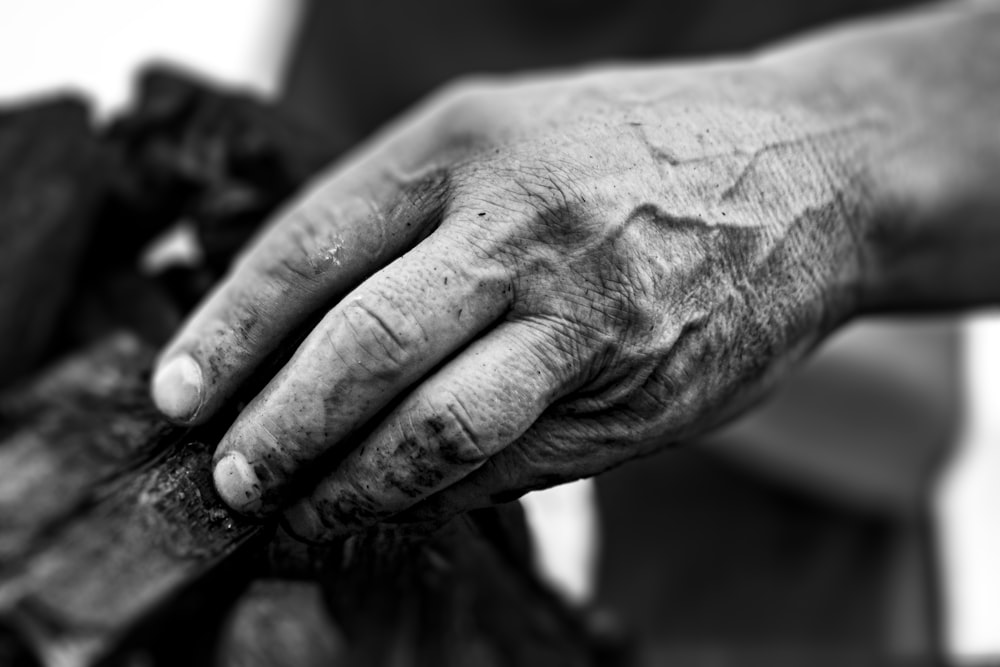 grayscale photo of persons hand