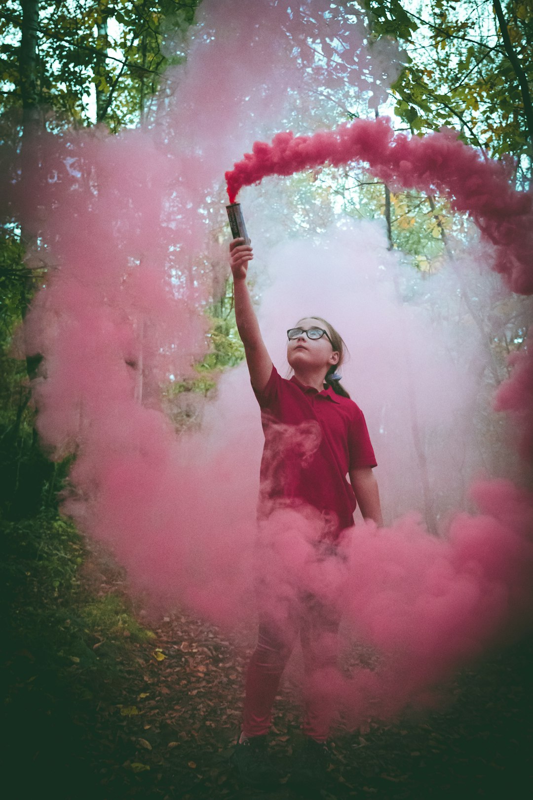 woman in red dress holding red smoke
