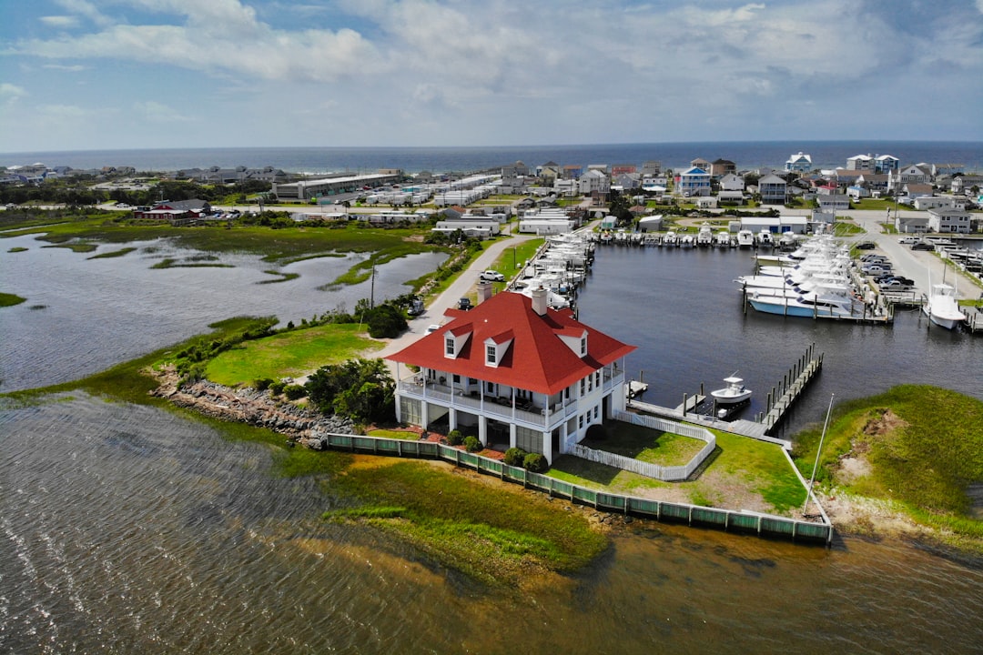 red and white house near body of water during daytime