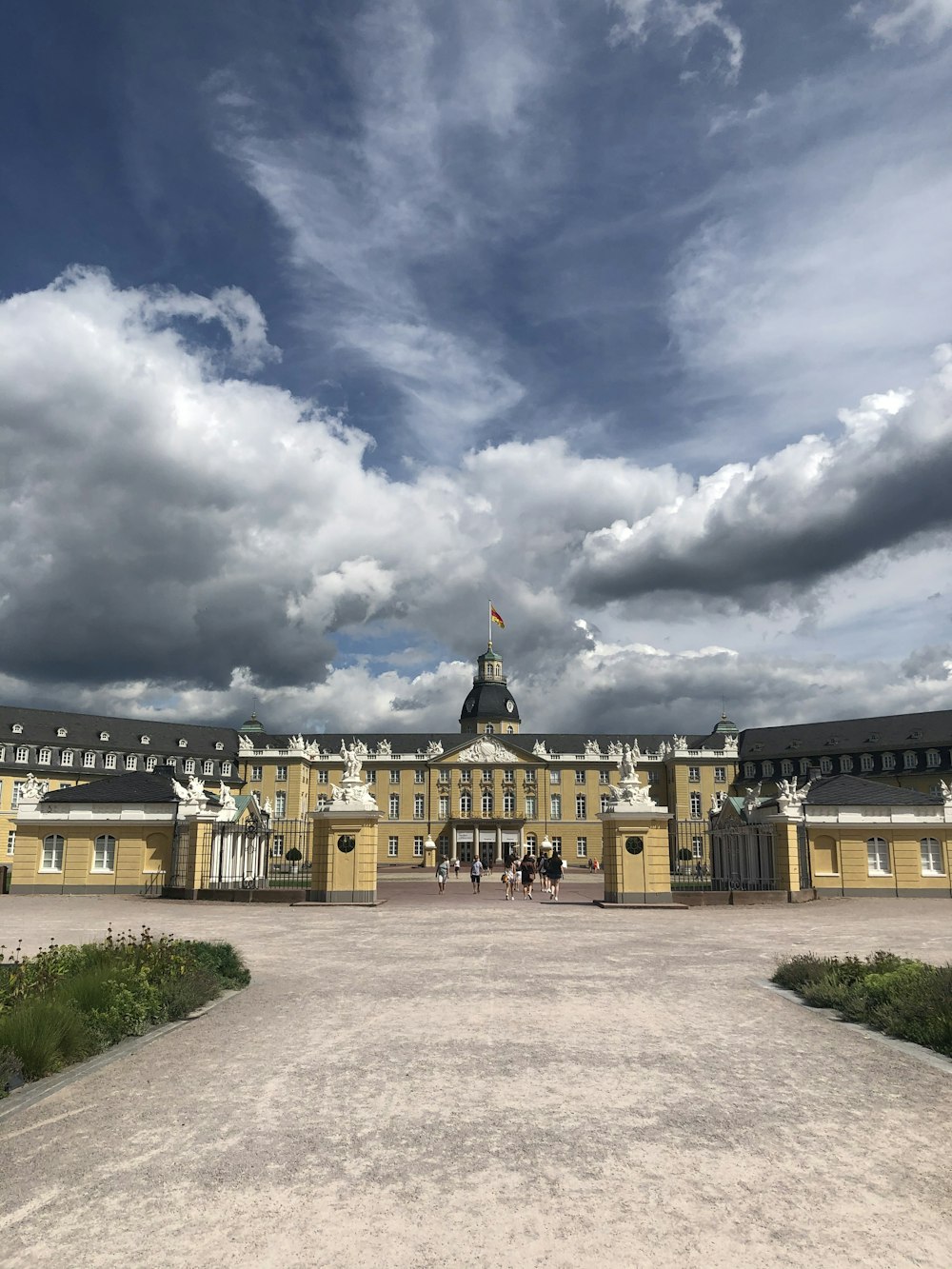 yellow and white concrete building under cloudy sky during daytime