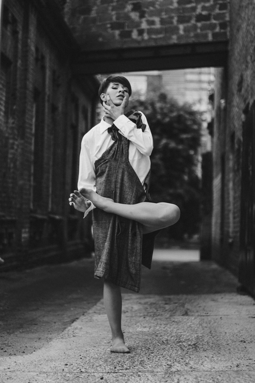 grayscale photo of woman in dress shirt and skirt