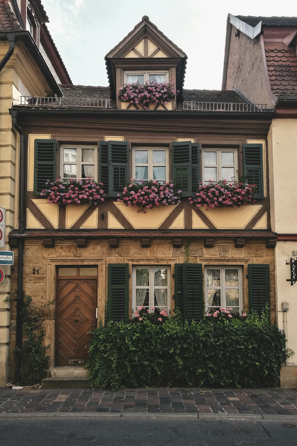 brown and white concrete house with green plants