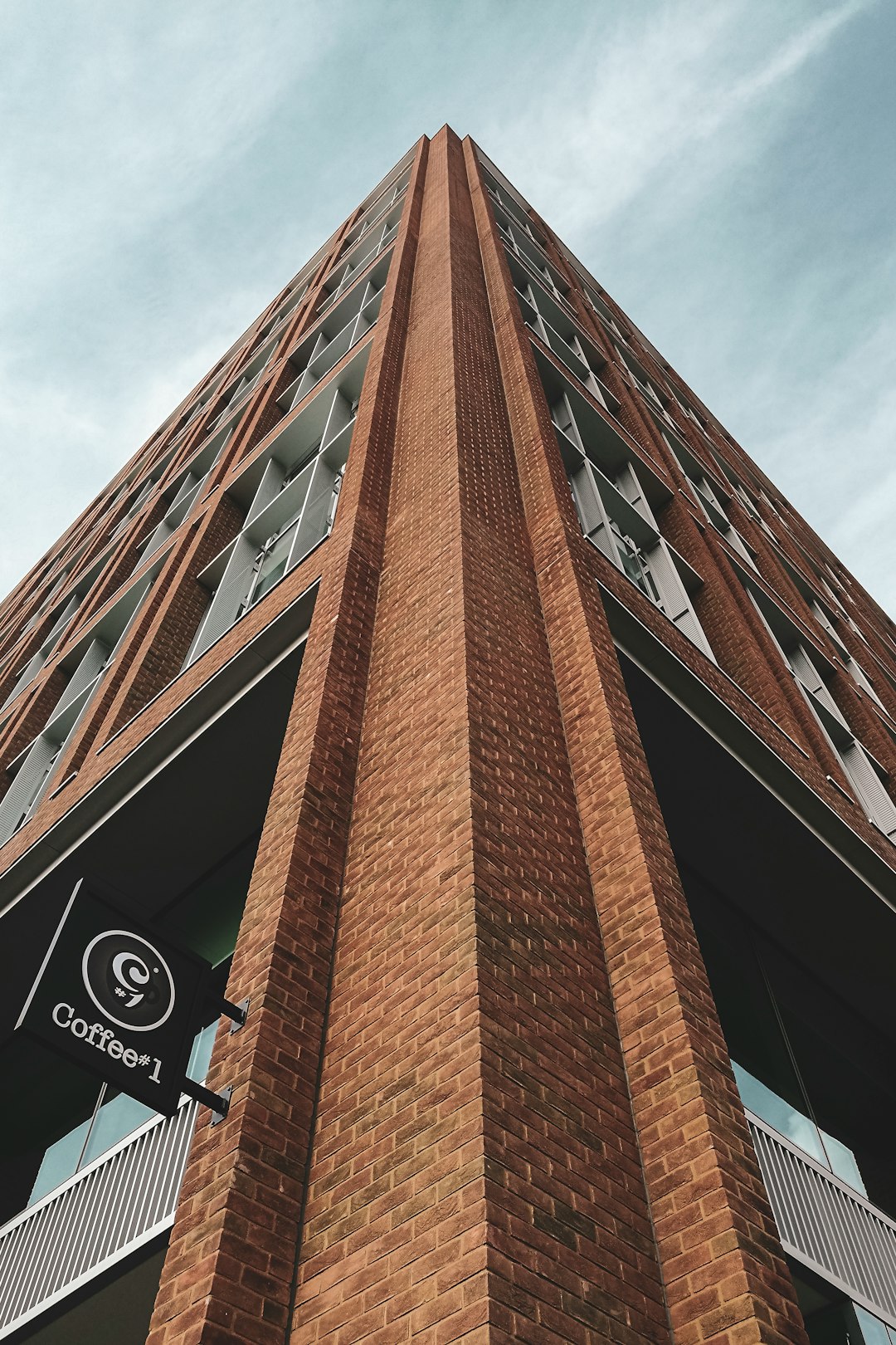 brown concrete building under white clouds during daytime