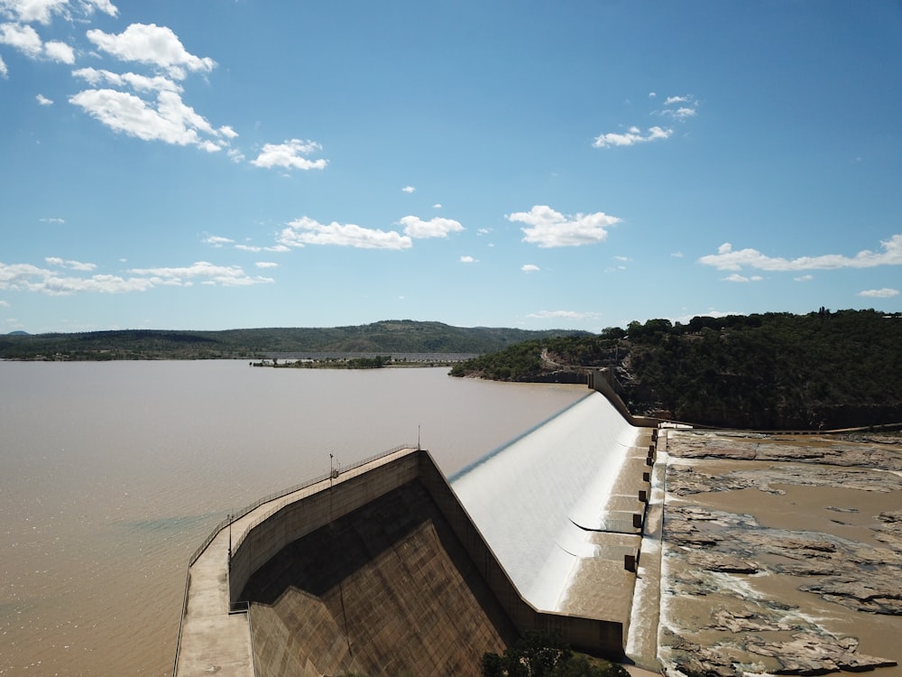 white concrete wall near body of water during daytime