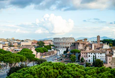 city with high rise buildings under white clouds during daytime