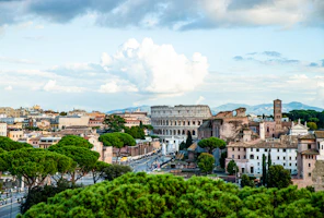 city with high rise buildings under white clouds during daytime