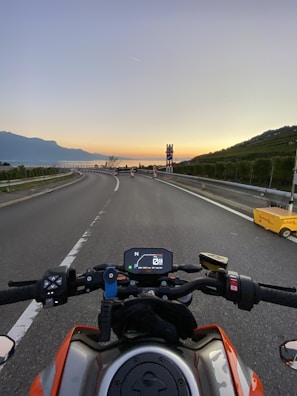 A sunset view over the mountains, captured during a motorcycle trip.
