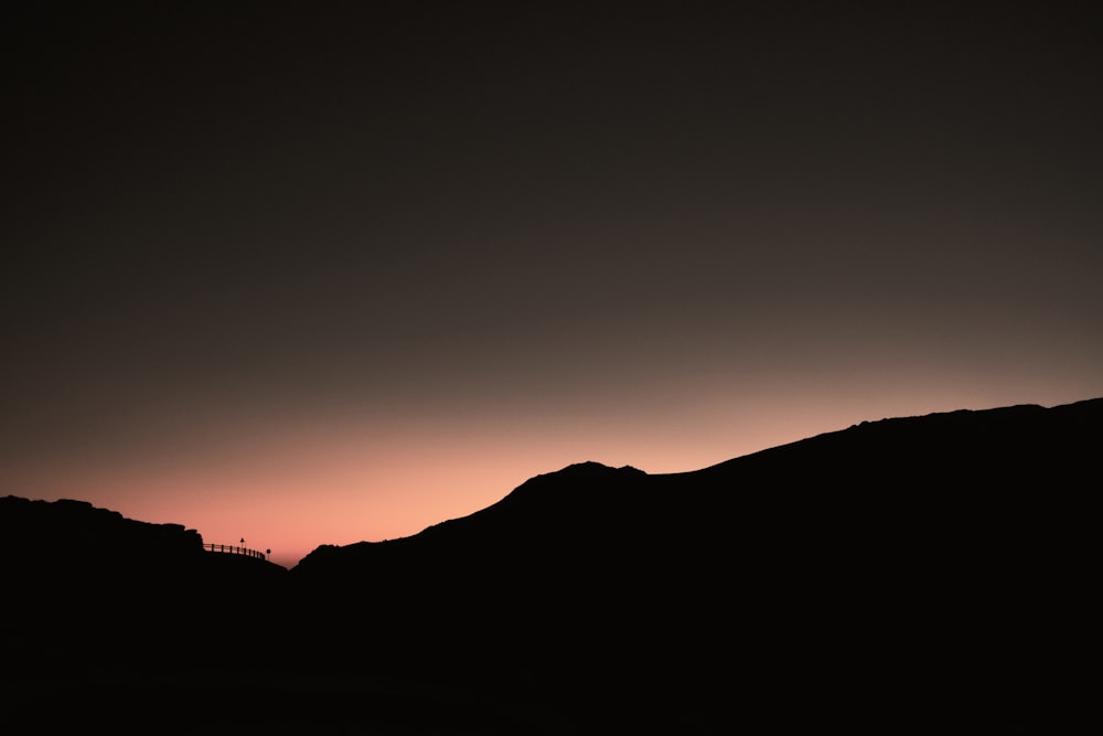 silhouette of mountain during sunset