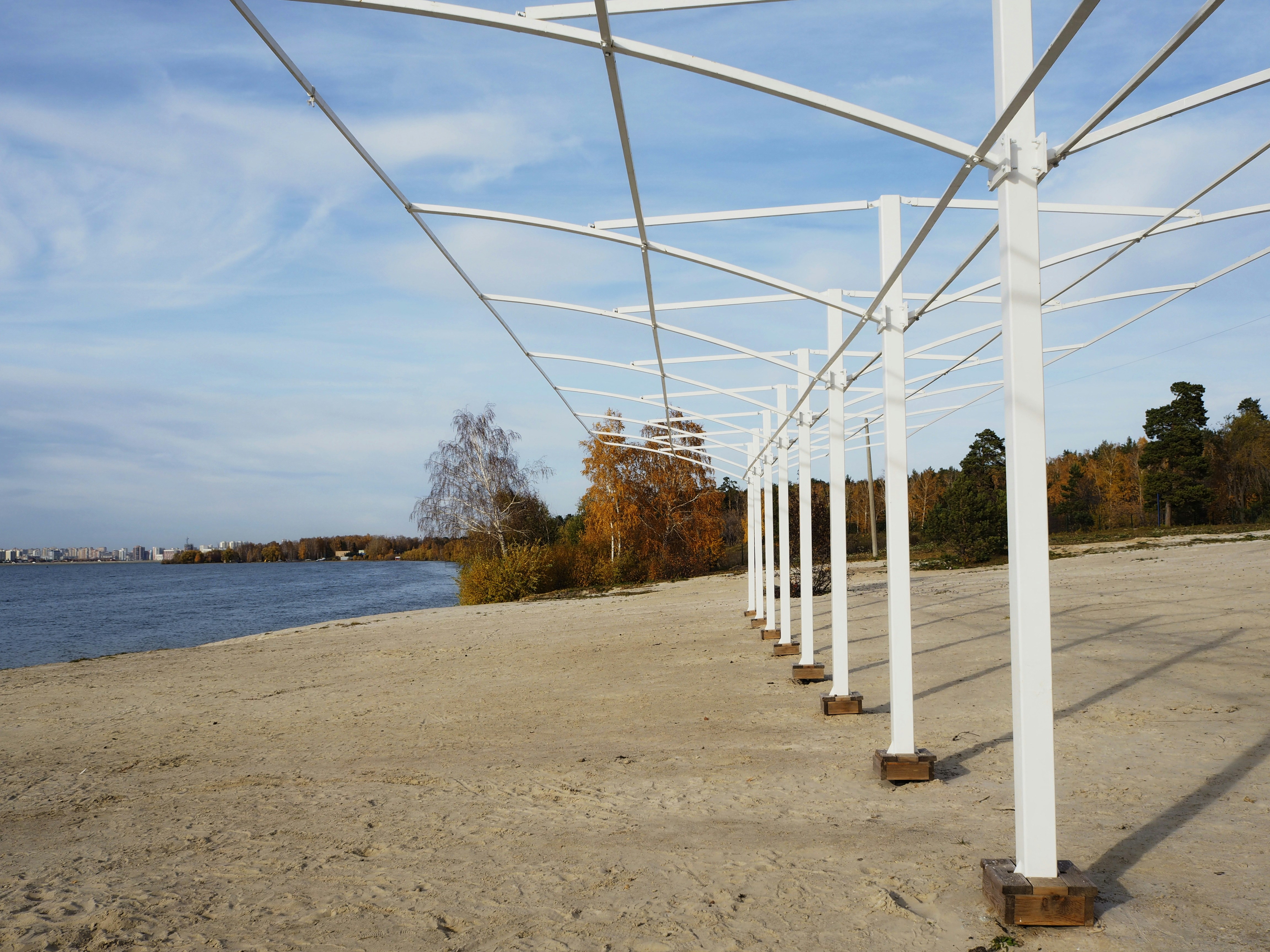 white metal bridge over the sea during daytime
