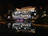 Elegant waterfront property with glowing architectural lights and illuminated garden beds.