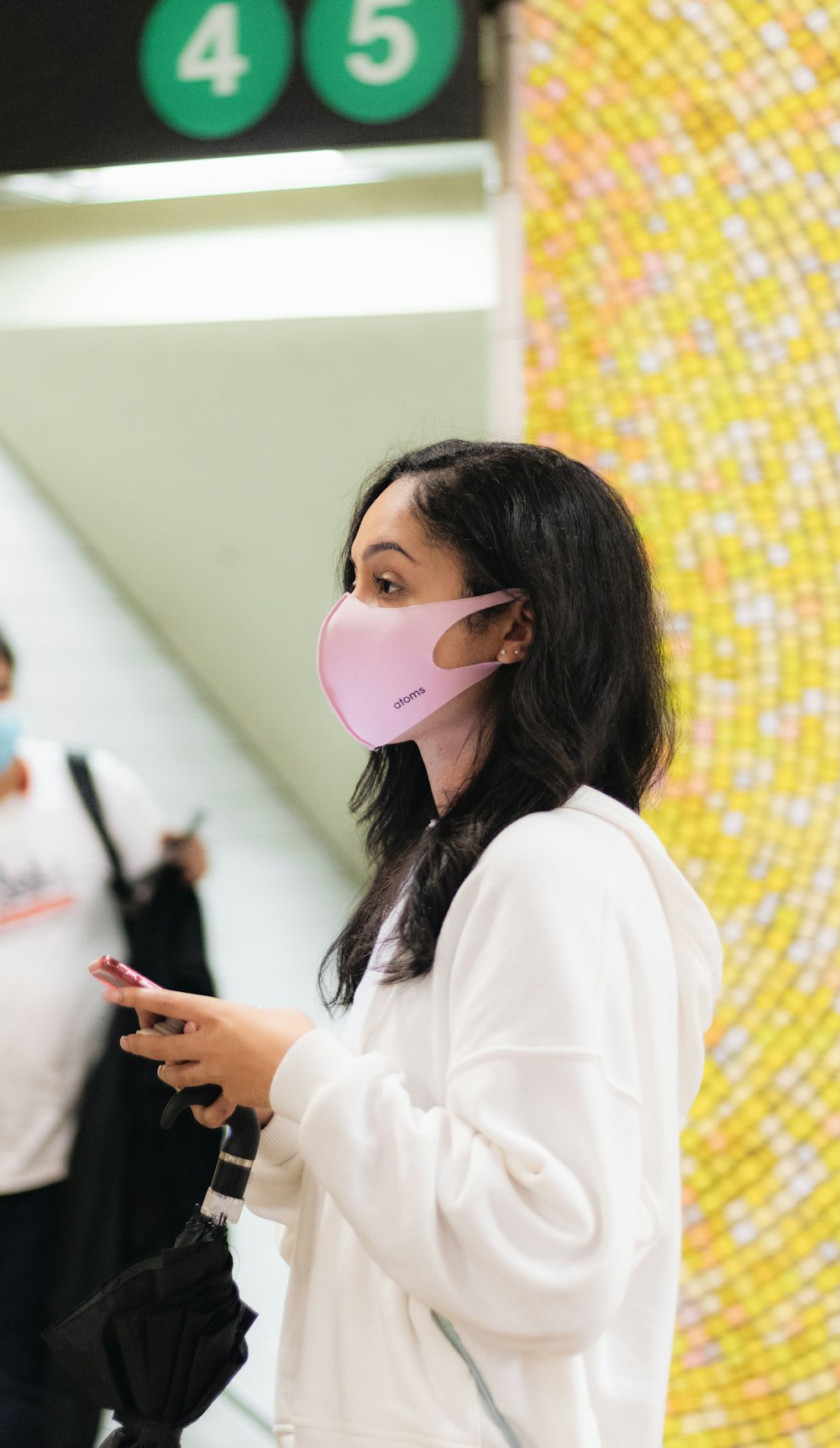 woman in white long sleeve shirt wearing white mask