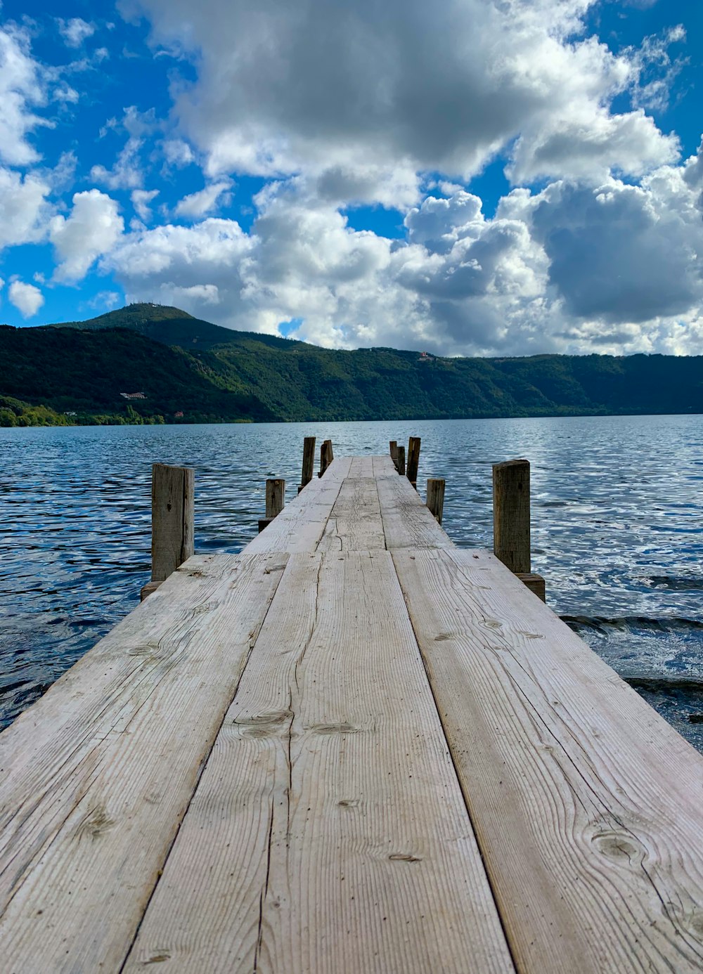 brown wooden dock on body of water during daytime