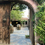 Owners warmly welcoming guests at the rustic entrance of the boutique winery.
