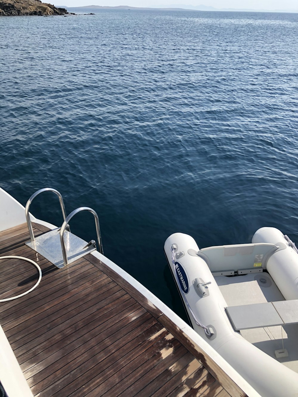 white boat on blue sea during daytime