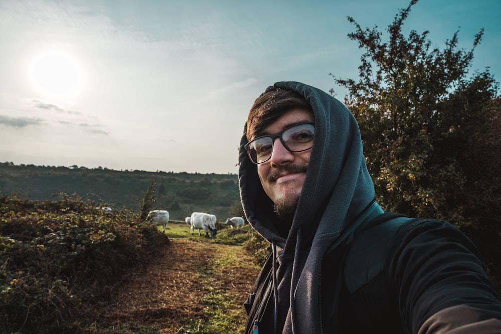 man in black hoodie wearing black framed eyeglasses